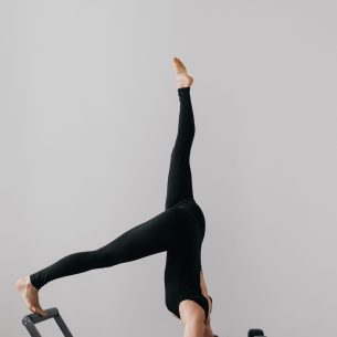 pilates-reformer-training-machine-sporty-woman-exercising-gym (1)